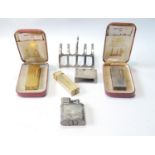 Dunhill EP storm lighter, 1940s, and another, engine turned, with case, two rolled gold lighters,
