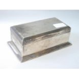 Silver cigarette box with engine turned top, on spreading base, Birmingham 1927, 18.5cm x 10.5cm.