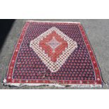 Persian Kilim rug decorated with a geometric diamond lozenge medallion to the centre and all over