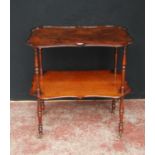 19th century mahogany window table, with two shaped tiers, on turned supports with brass castors,