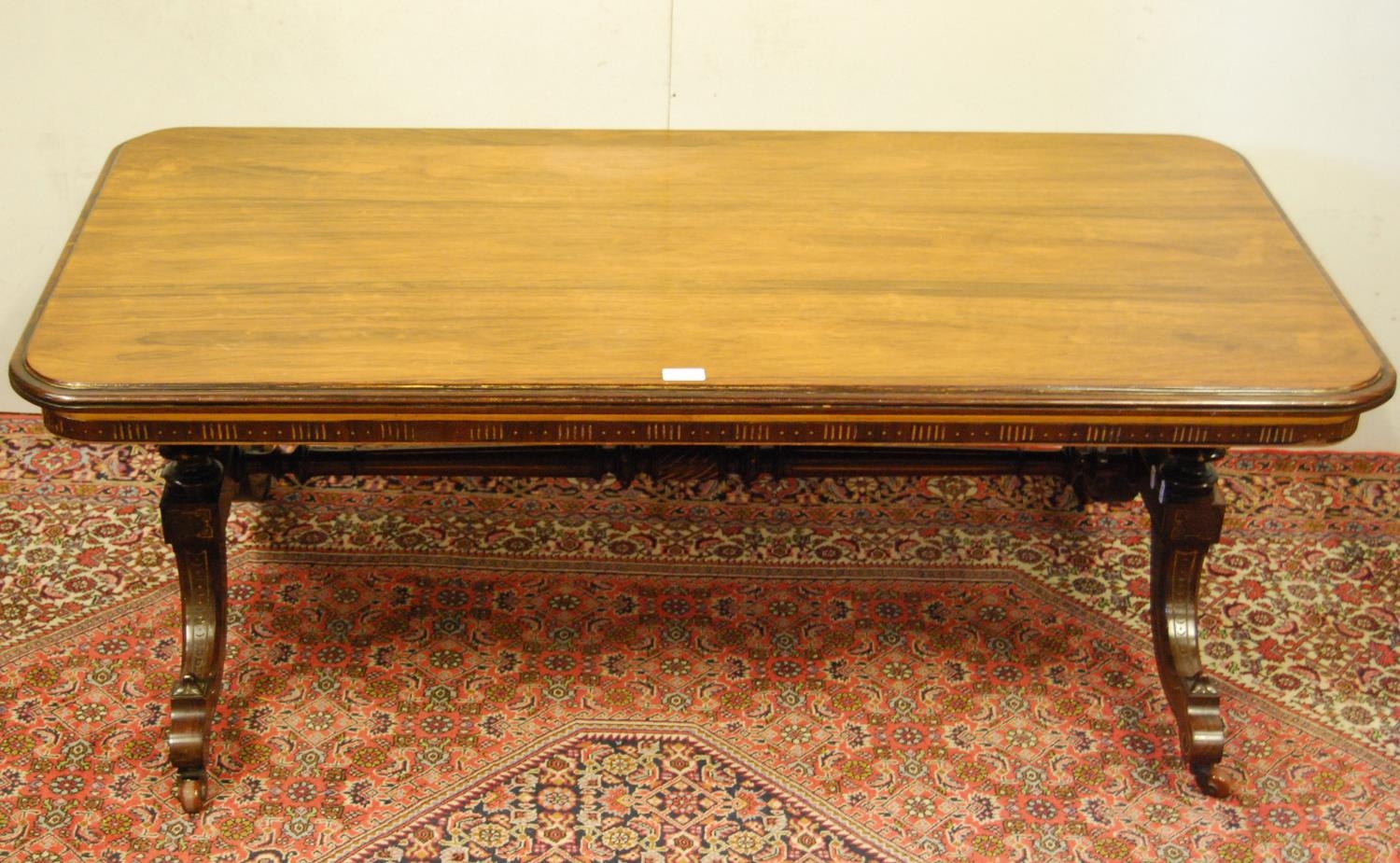 19th century rosewood and parcel gilt coffee table, the rectangular top with canted corners on three