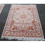 Persian Kashan rug decorated with all over floral swags on a cream, orange and beige ground, 187cm x