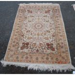 Persian Kashan rug decorated with all over floral swags on a cream, orange and beige ground, 177cm x