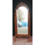 Victorian mahogany cheval mirror, the pierced scroll and fern pediment above an arched plate glass