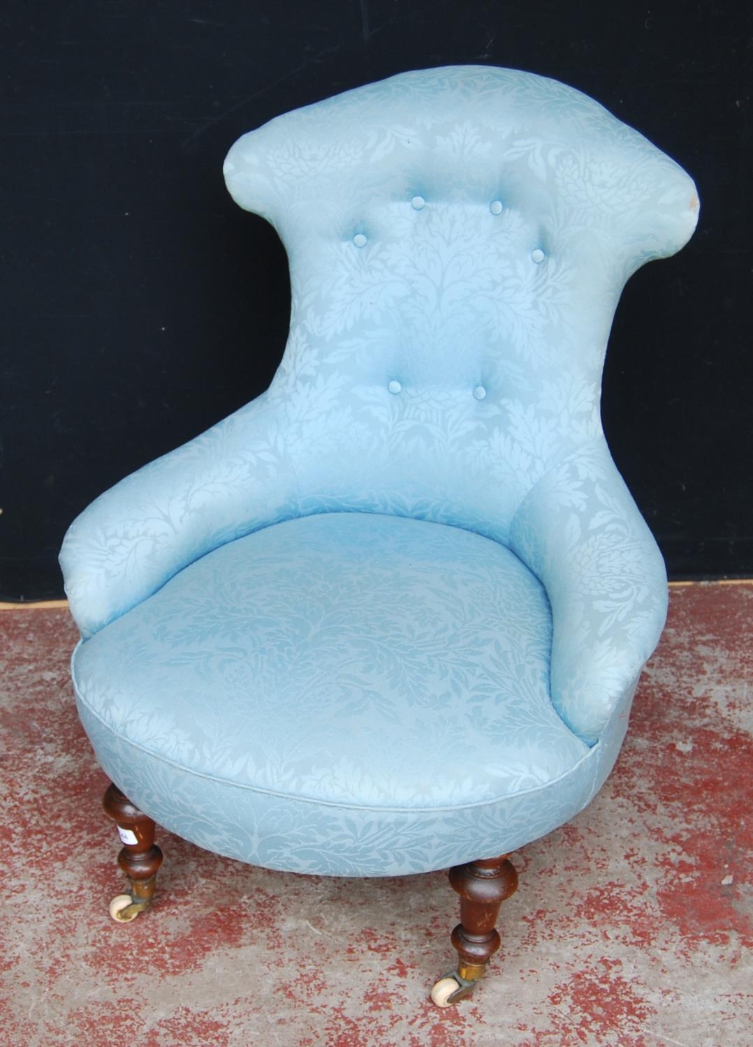 19th century mahogany lady's armchair, the shaped back rest upholstered in later blue button-back