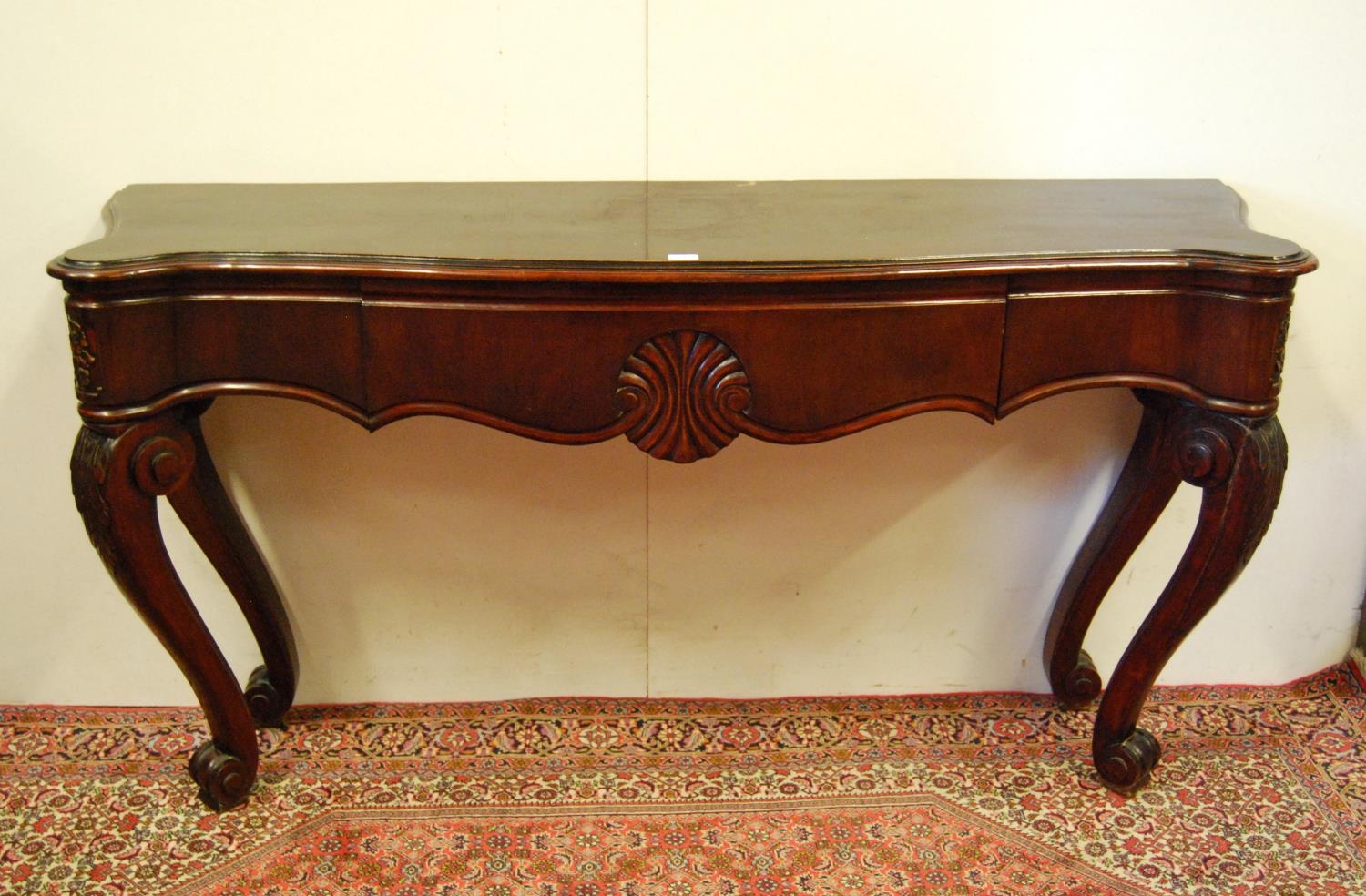 Victorian-style mahogany console table, the rectangular top with canted corners above a long