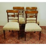Set of four Regency-style mahogany dining chairs, each with a tablet top above a pierced bow and