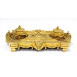 Gilt metal desk stand with two integral inkwells, with two open quill wells and applied classical-