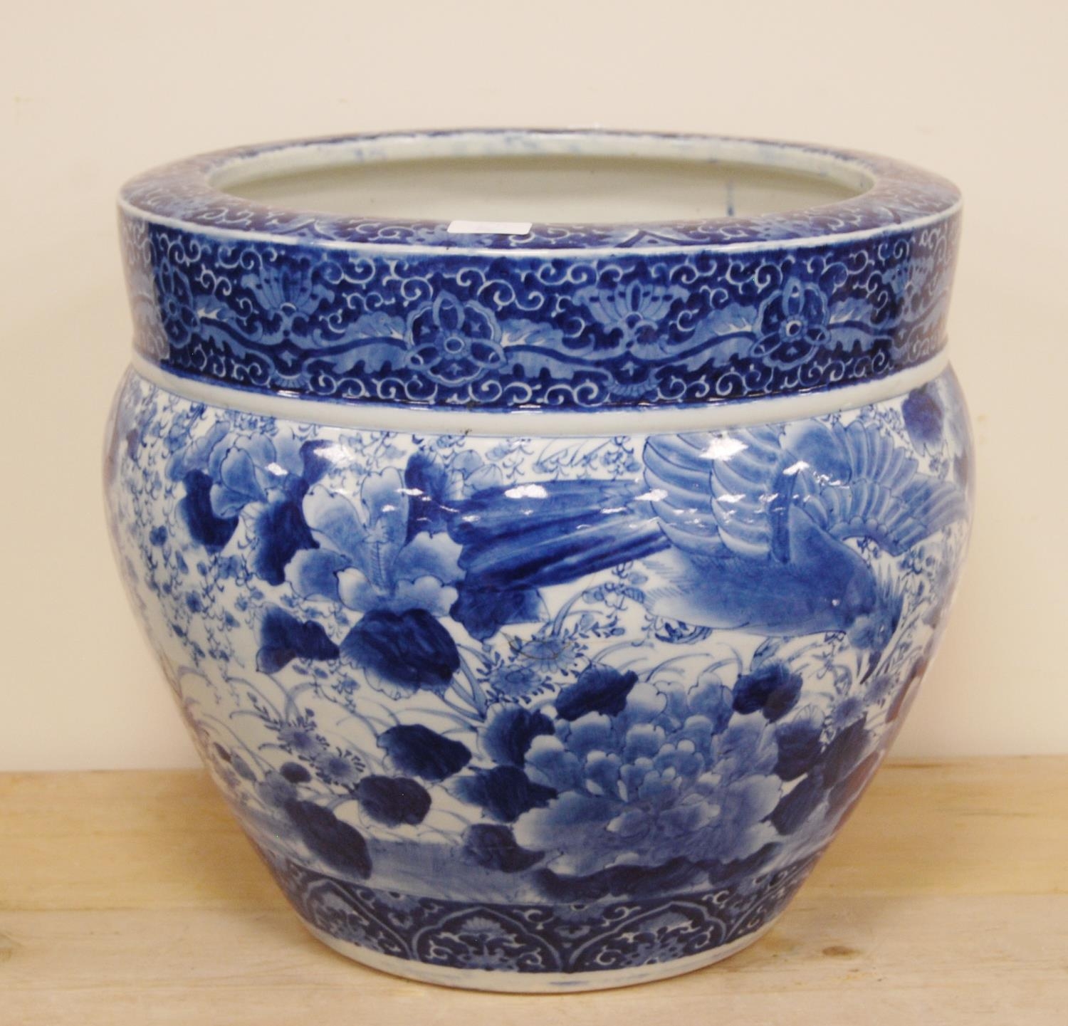 Large Chinese-style blue and white pottery jardinière with all over decoration of birds in