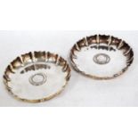 Pair of silver circular strawberry dishes of George I style, copper gilt with inset shillings, 1787,