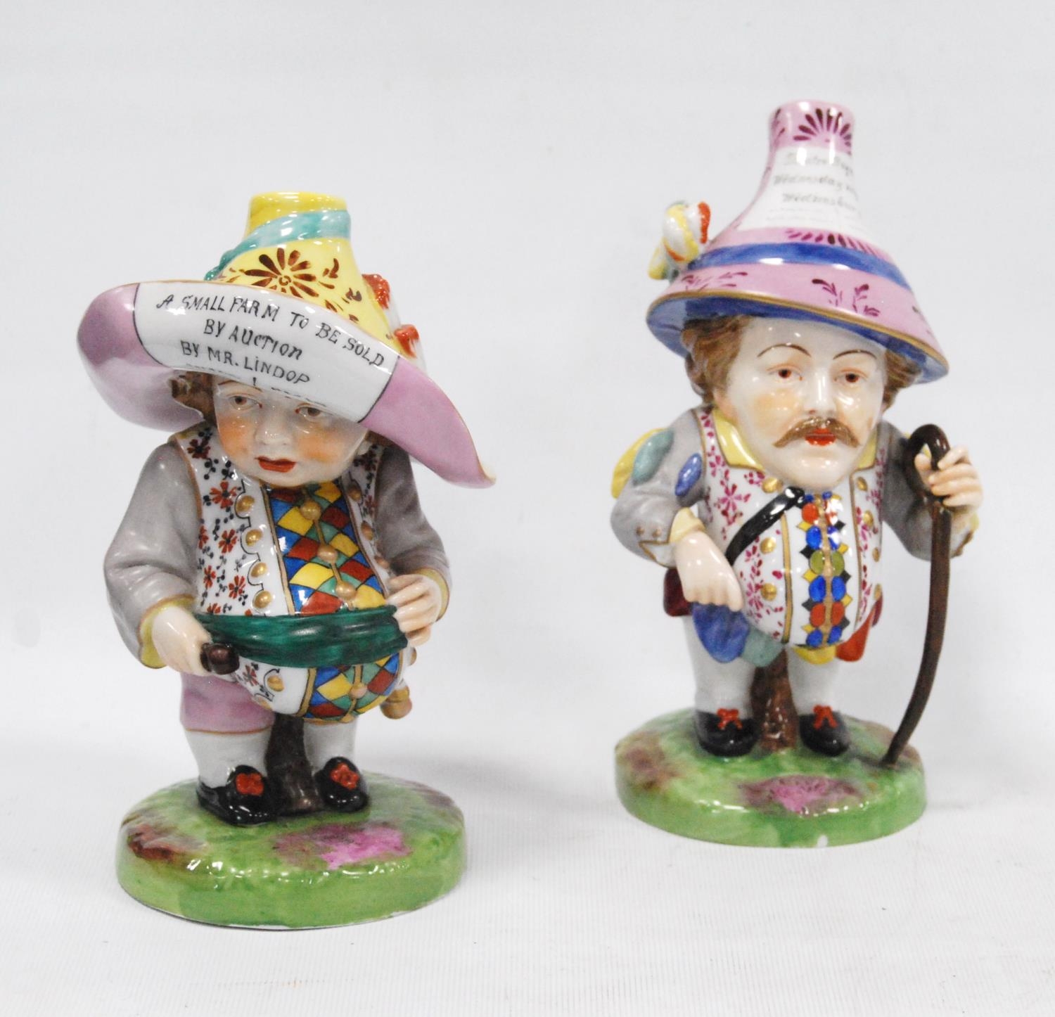 Pair of early 20th century Royal Crown Derby Mansion House dwarf figures, both bearing slogans to