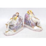 Pair of Art Deco German porcelain bookends modelled as a male and female sitting on armchairs,