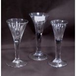 Three 18th century style antique cordial glasses, each with trumpet-shaped bowl, air bubble to the