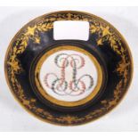 19th century Sèvres porcelain shallow dish, monogrammed in pink and green to the well, on a white