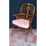 19th century ash and elm Windsor armchair, the hoop stick back with a pierced splat and dish seat,