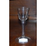 Mid 18th century wine glass with round funnel bowl, plain stem and circular foot, c. 1740, 15cm