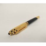 Panthere de Cartier rolled gold fountain pen, black with inlaid spots and ribbed cap and terminal.