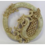 Chinese pierced and carved white and green mottled jade circular panel in the form of a curled