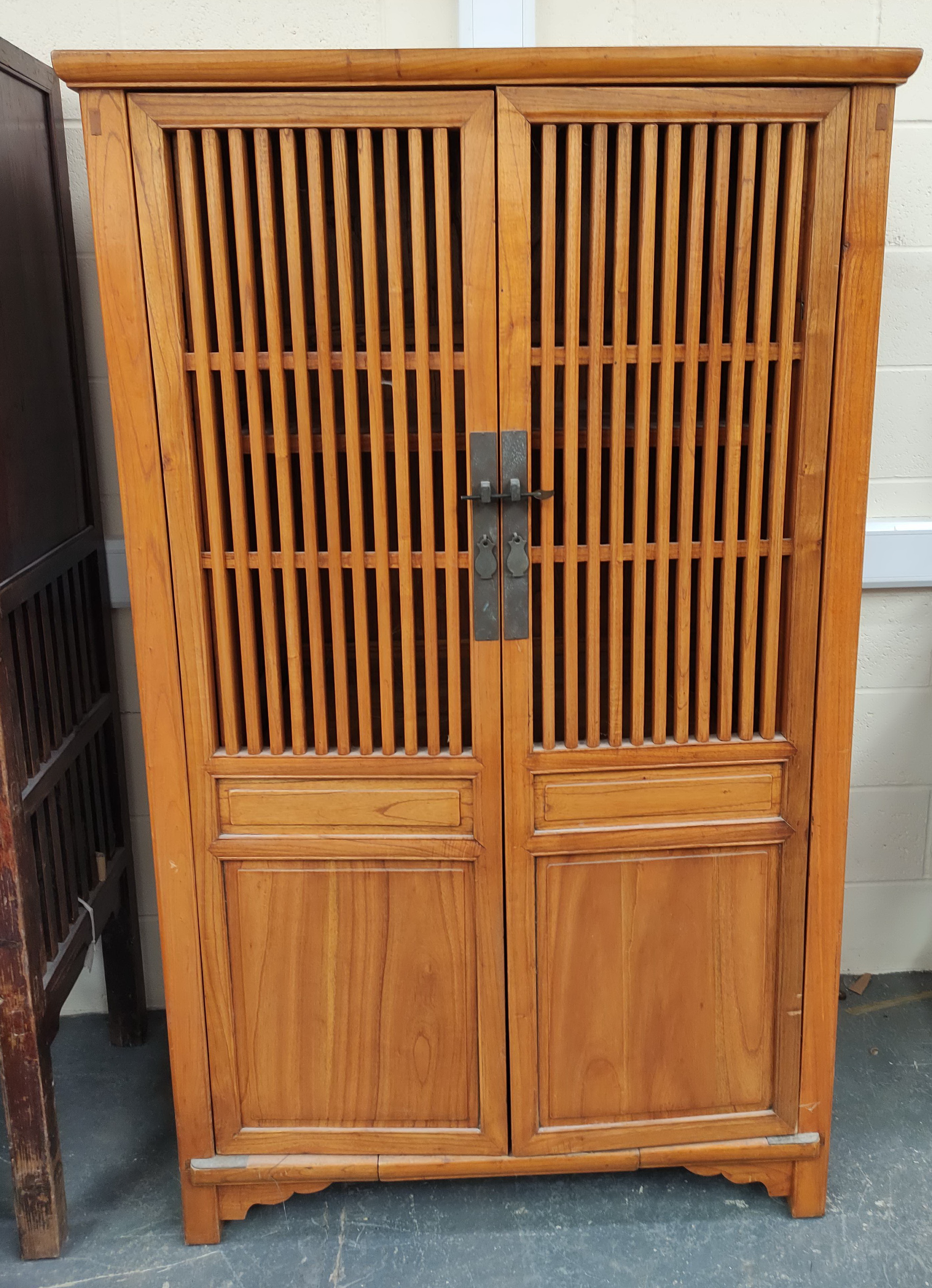 Chinese elm food cupboard, with large slatted doors enclosing a shelved interior with metal