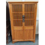 Chinese elm food cupboard, with large slatted doors enclosing a shelved interior with metal