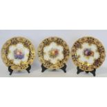 Three Royal Worcester porcelain dessert plates of lobed circular form with hand painted central