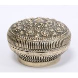 Oriental Siamese silver circular covered box with repousse central flowerhead surrounded by floral