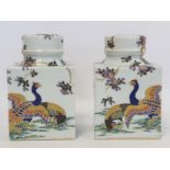 Pair of Japanese porcelain tea canisters of square form with circular covers and circular inner