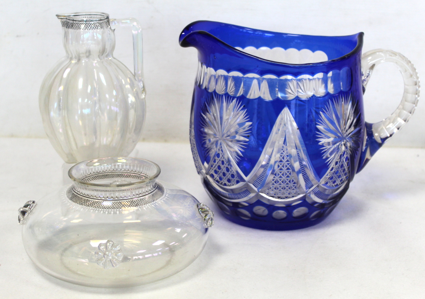 Bohemian blue flashed cut glass water jug of helmet form, 19.5cm high; a pearlescent clear glass