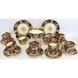 Early 19th century English porcelain part tea set with polychrome painted floral panels on a dark