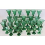 Art Deco green lustre glass part suite of drinking glasses, all with conical bowls on short