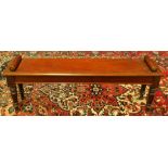 Late Victorian mahogany hall bench with a cylindrical scroll terminal to either side of the seat, on