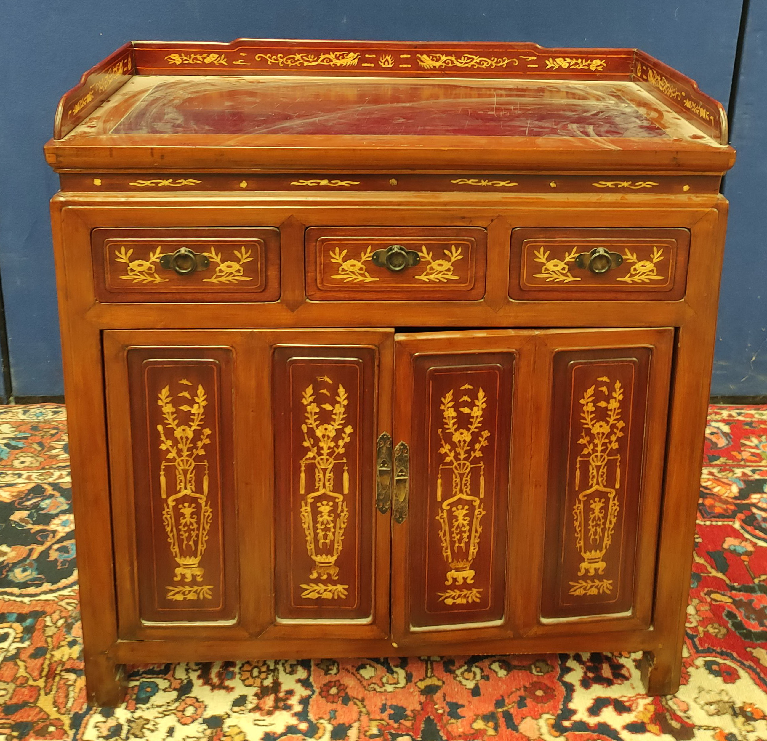 Chinese inlaid hardwood cupboard with a three-quarter gallery above three short drawers and two