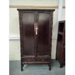 Antique Chinese lacquer cabinet, With two large doors enclosing a shelved interior, above two