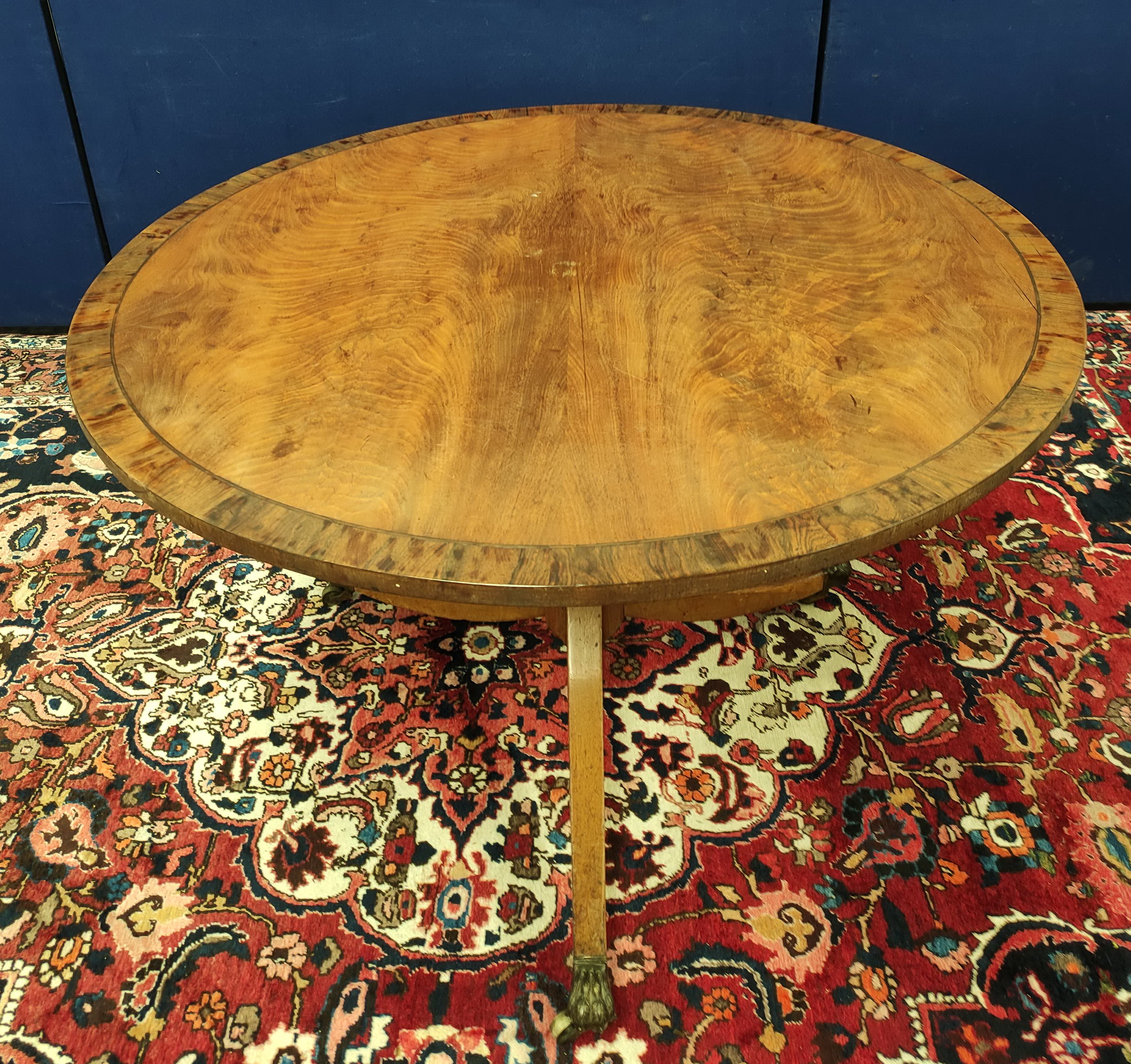 Mahogany breakfast table, the circular snap-action top on a turned column and tripod supports,