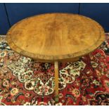 Mahogany breakfast table, the circular snap-action top on a turned column and tripod supports,