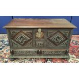 Continental carved coffer, the hinged rectangular top with metal lock and escutcheon, carved