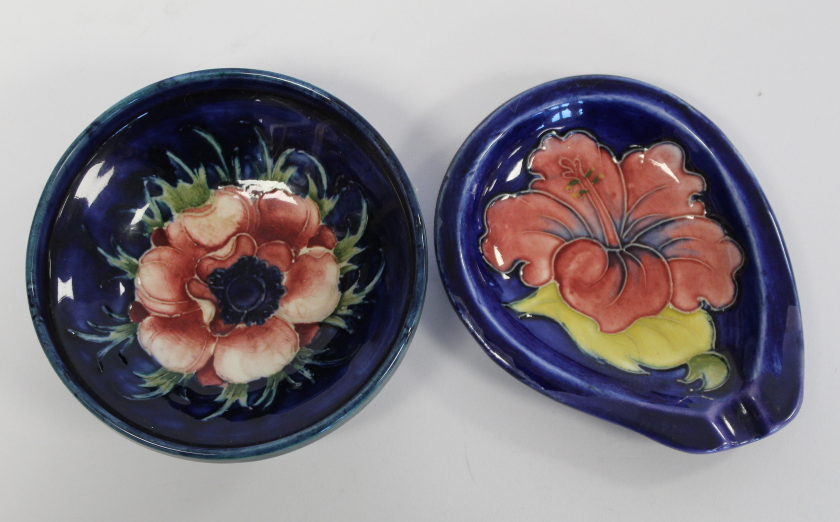 William Moorcroft "Anemone" pattern small circular footed sweetmeat dish with blue ground, 7.5cm