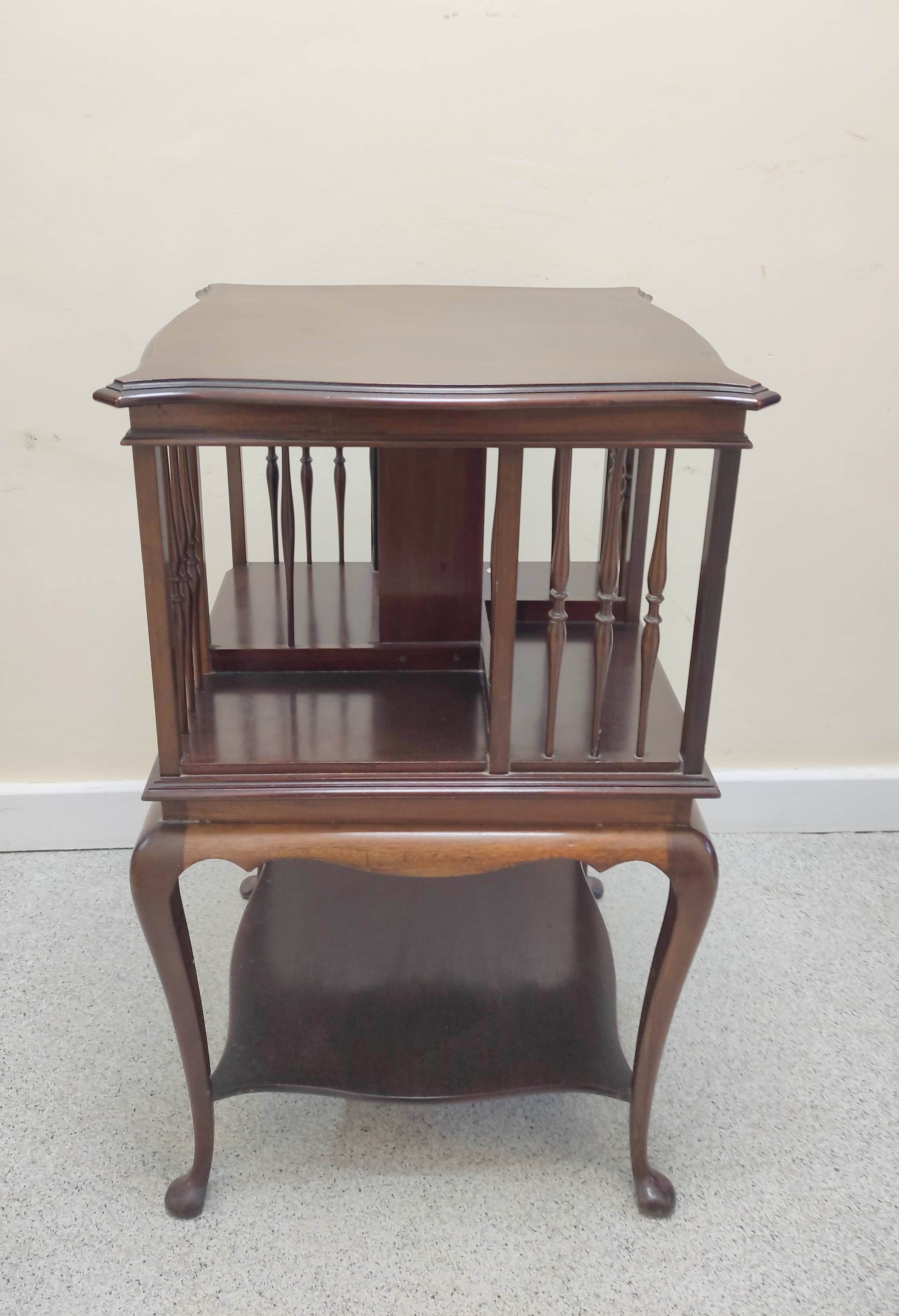 Edwardian mahogany revolving bookcase with serpentine revolving open top above a table base raised