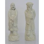 Two Chinese white crackle glazed figures of Lohan, each 22.5cm high.  (2).