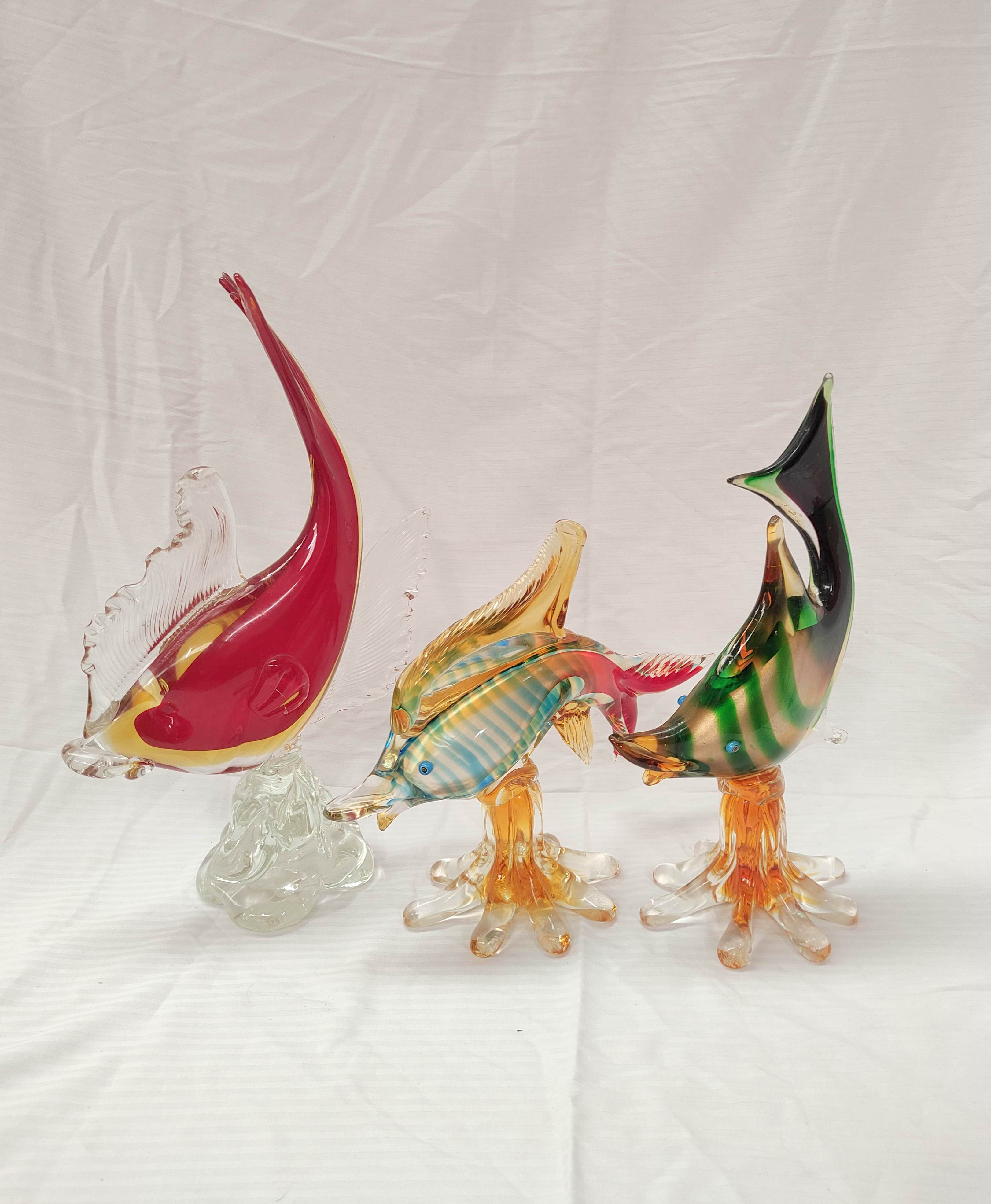 Three mid 20th century art glass figures of leaping fish, 38cm, 32cm and 23cm high.  (3).