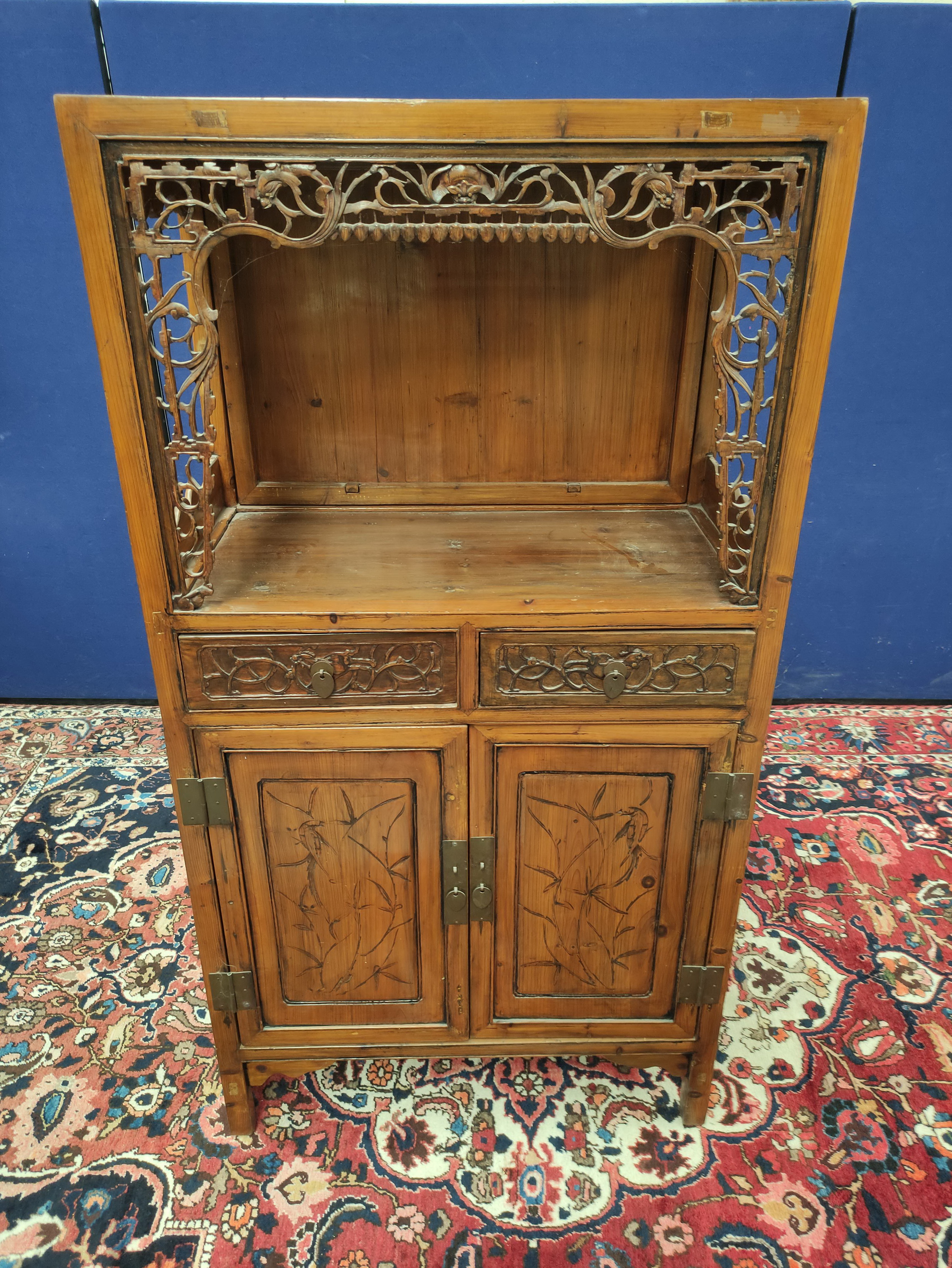 Chinese pine cupboard, with an open section to the top, decorated with Chinese fretwork, above two