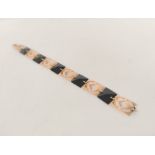 Edwardian bracelet with five onyx panels and pierced gold panels, '9ct', 8.4g gross.