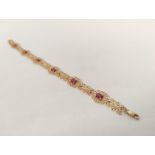 Gold bracelet with six oval rubies on openwork, '9k', 6.6g.