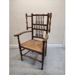 Lancashire-style ash and elm open armchair, with spindle decoration to the back rest, flanked by a
