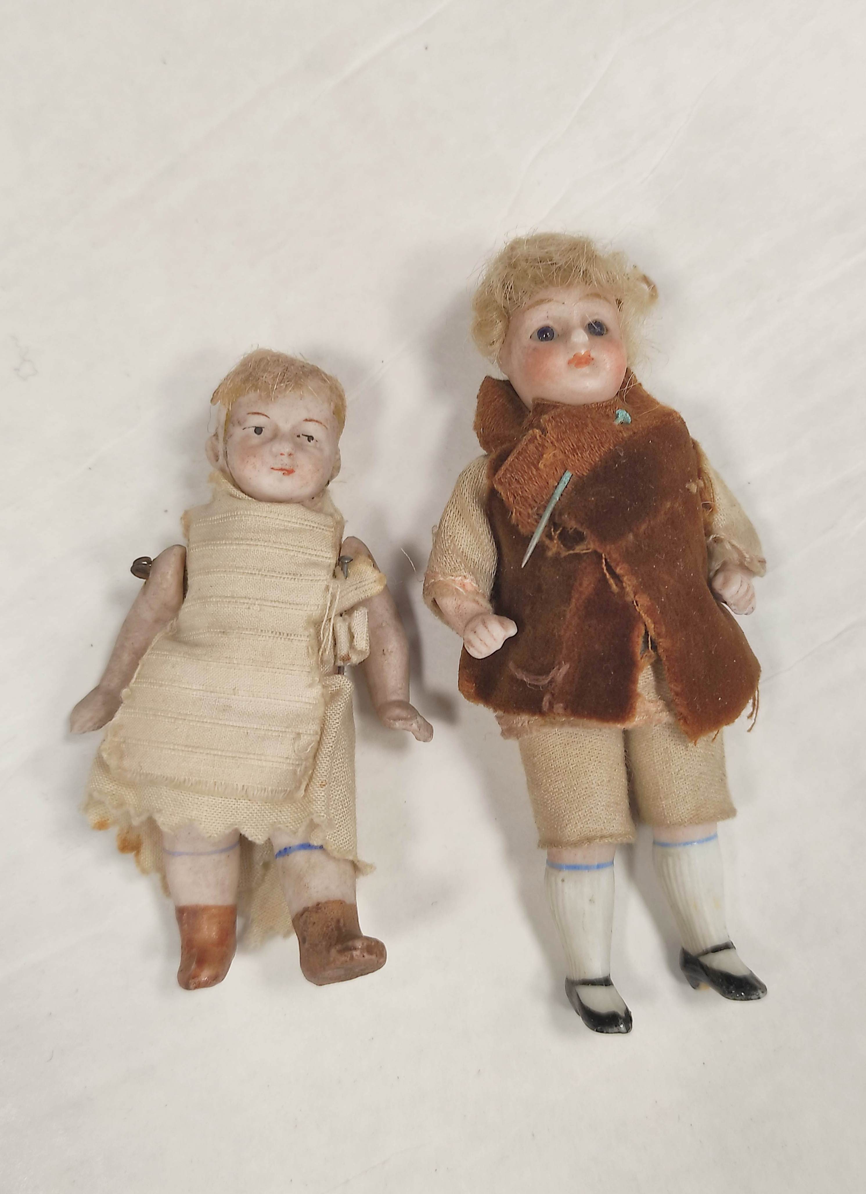 Two 19th century Victorian porcelain child's dolls with applied painted features. (2)