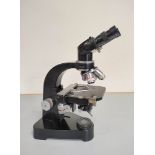 Vintage Ernst Leitz Wetzlar binocular microscope with four rotating lenses. Lacking power supply and