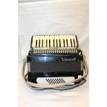 Parrot piano accordion in hard fitted case with velvet interior.