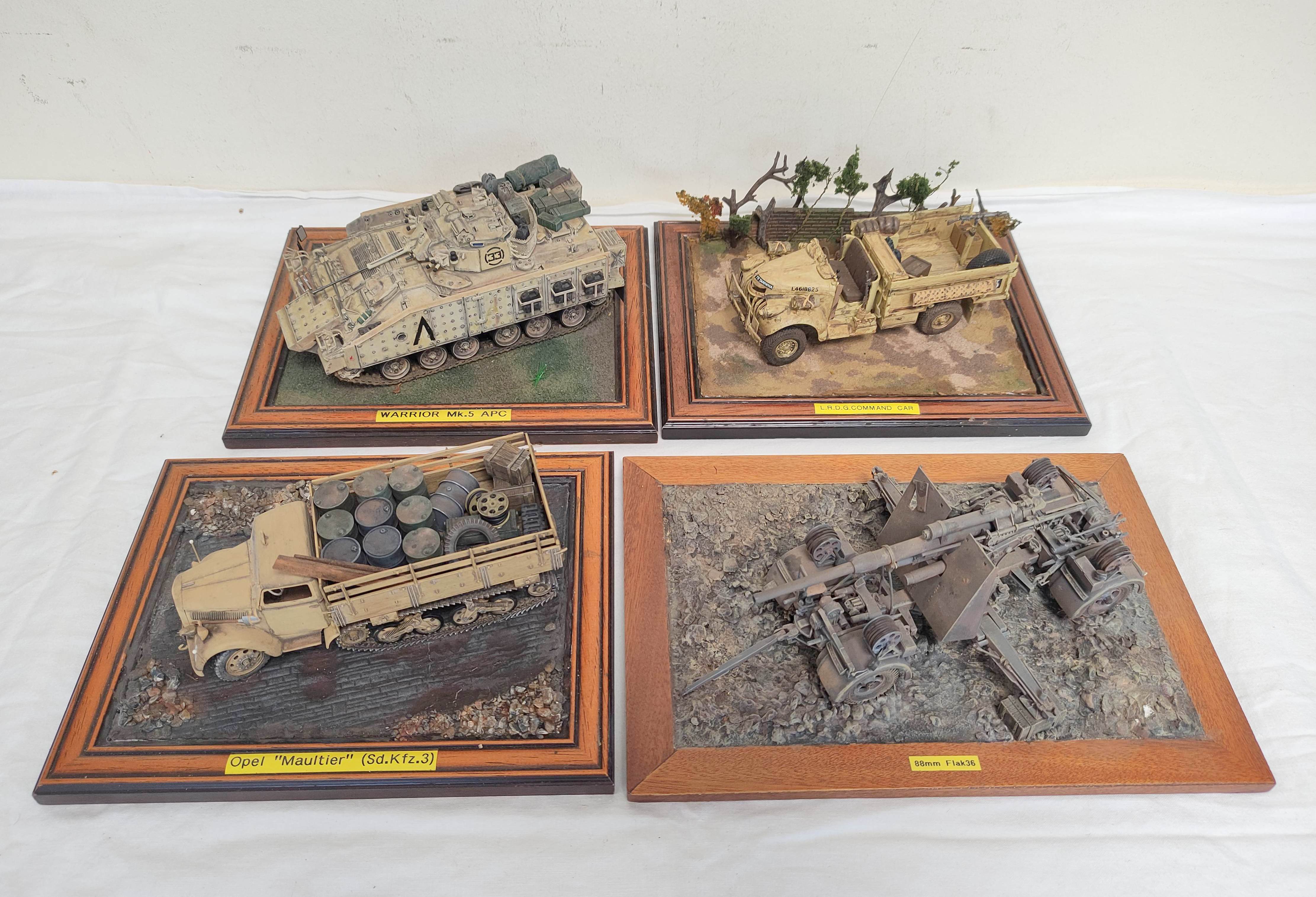 Four collector's model military vehicles. To include a Warrior MK5 A.P.C, British Tamiya L.R.D.G