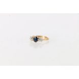 Gold, diamond and sapphire three stone lady's ring, the central sapphire flanked by two diamonds,