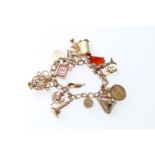 9ct gold curb link charm bracelet with fifteen dependant charms to include a 1906 half sovereign,